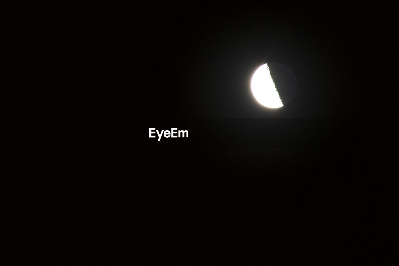 LOW ANGLE VIEW OF MOON AGAINST CLEAR SKY