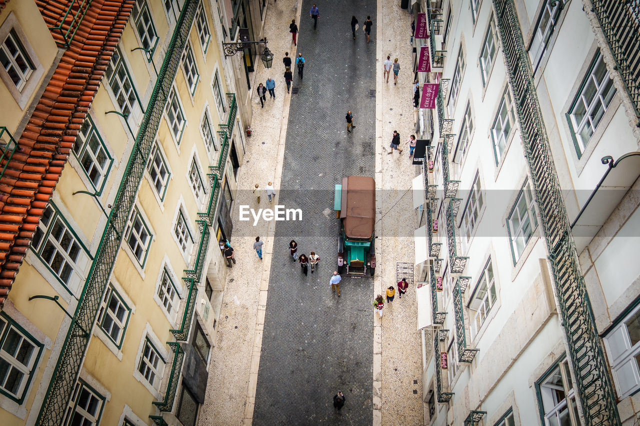 High angle view of people walking on street of city