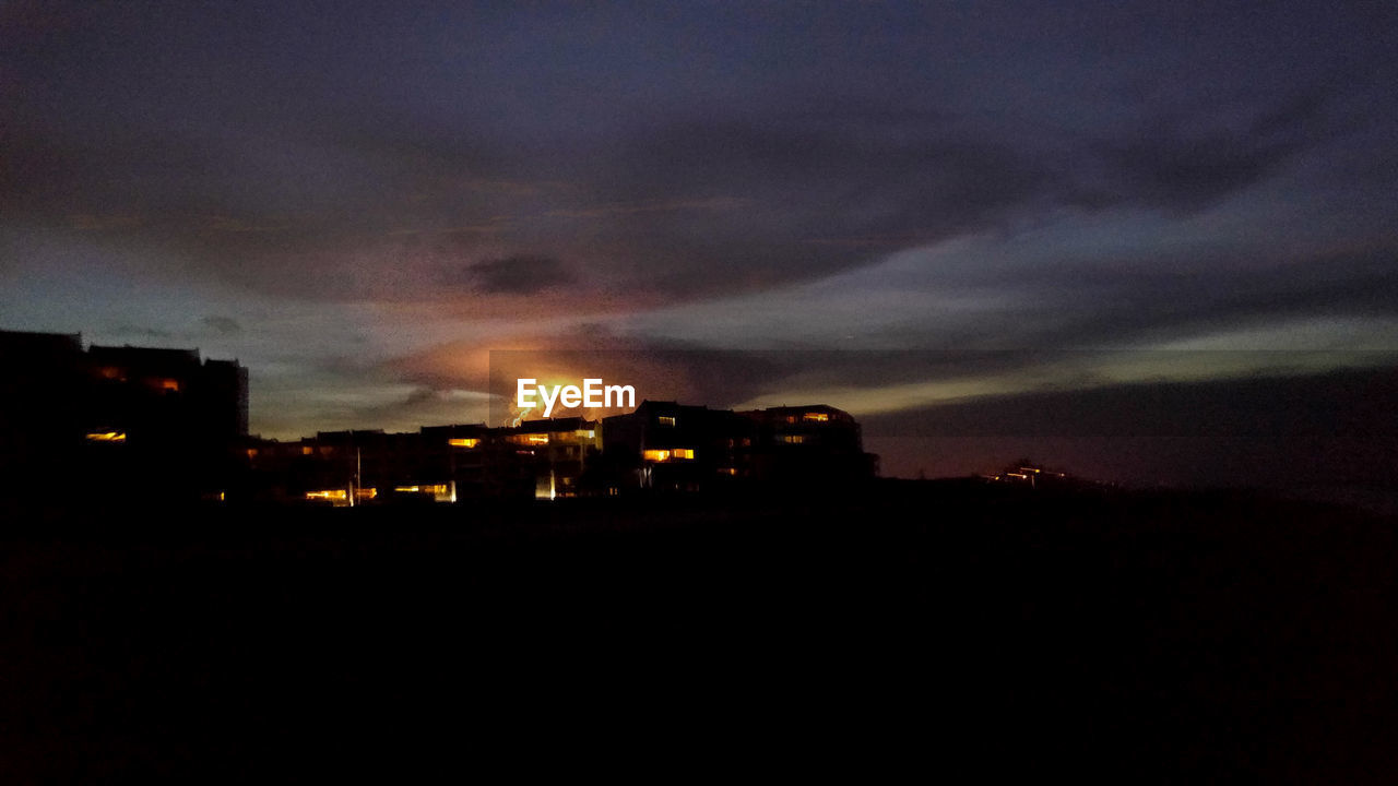 VIEW OF ILLUMINATED CITY AT NIGHT