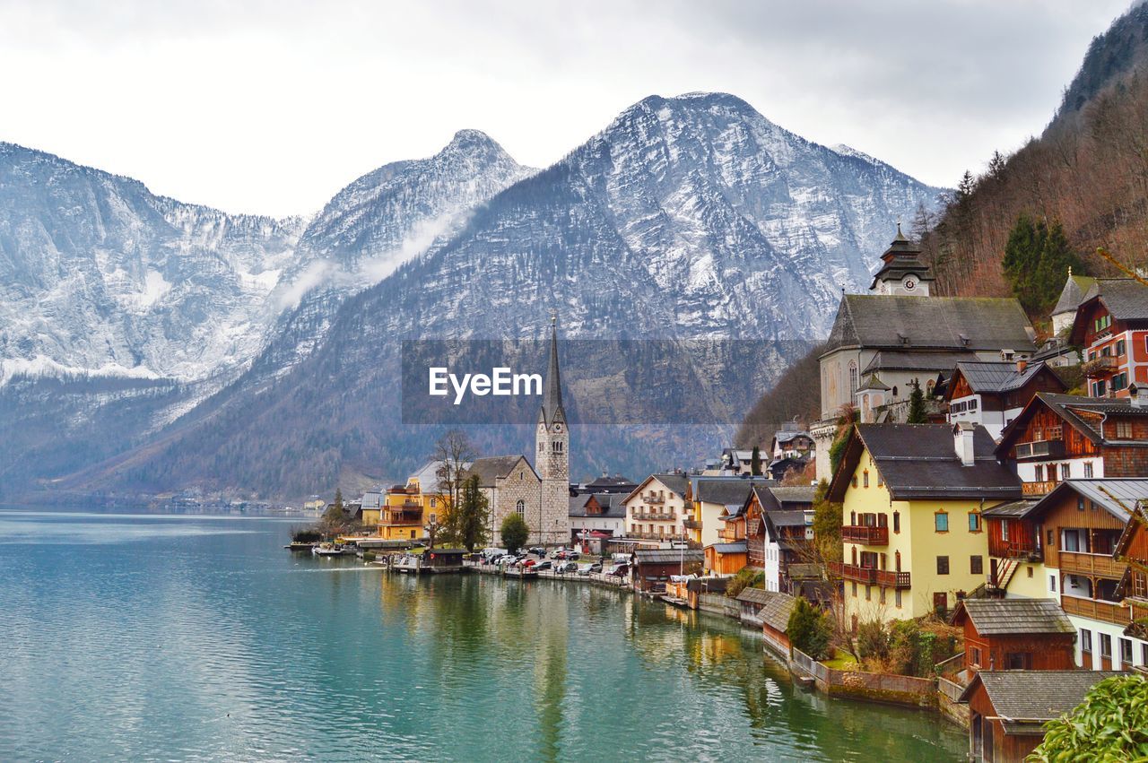 Panoramic view of lake and buildings against sky