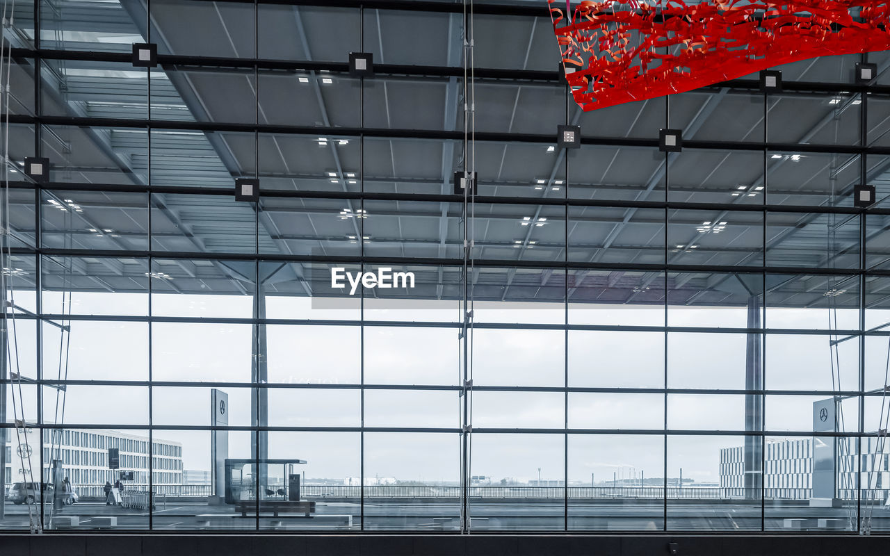 LOW ANGLE VIEW OF GLASS WINDOW IN AIRPORT BUILDING