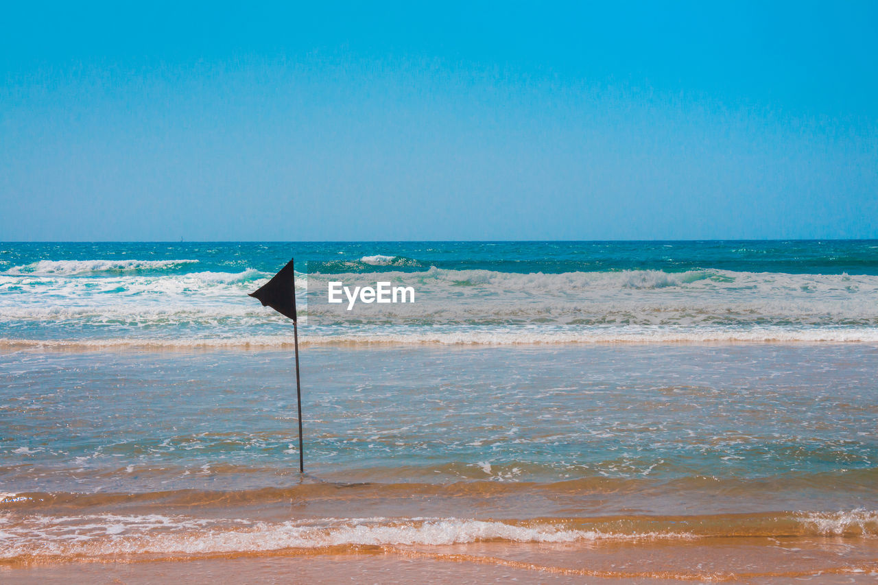 SCENIC VIEW OF BEACH AGAINST CLEAR SKY