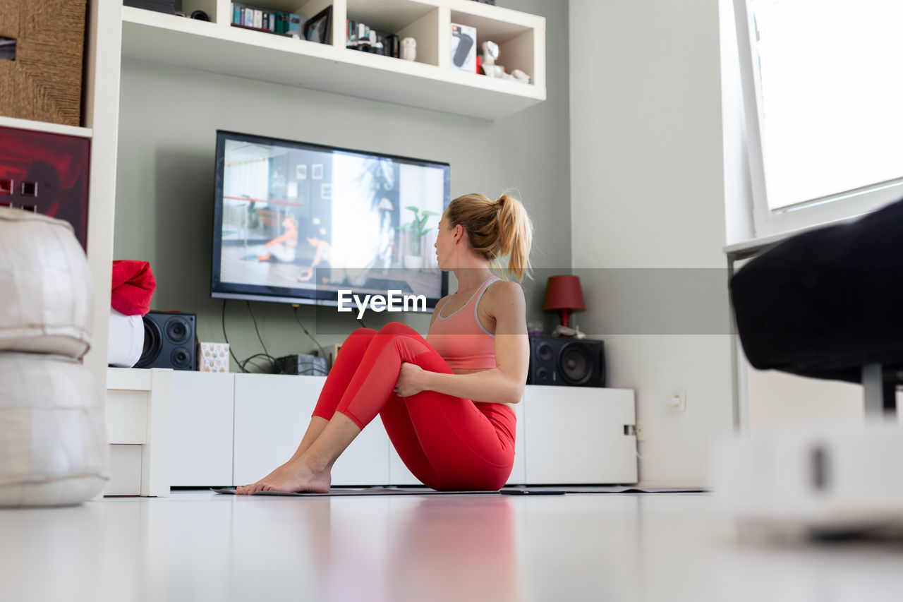 WOMAN SITTING IN SOFA AT HOME