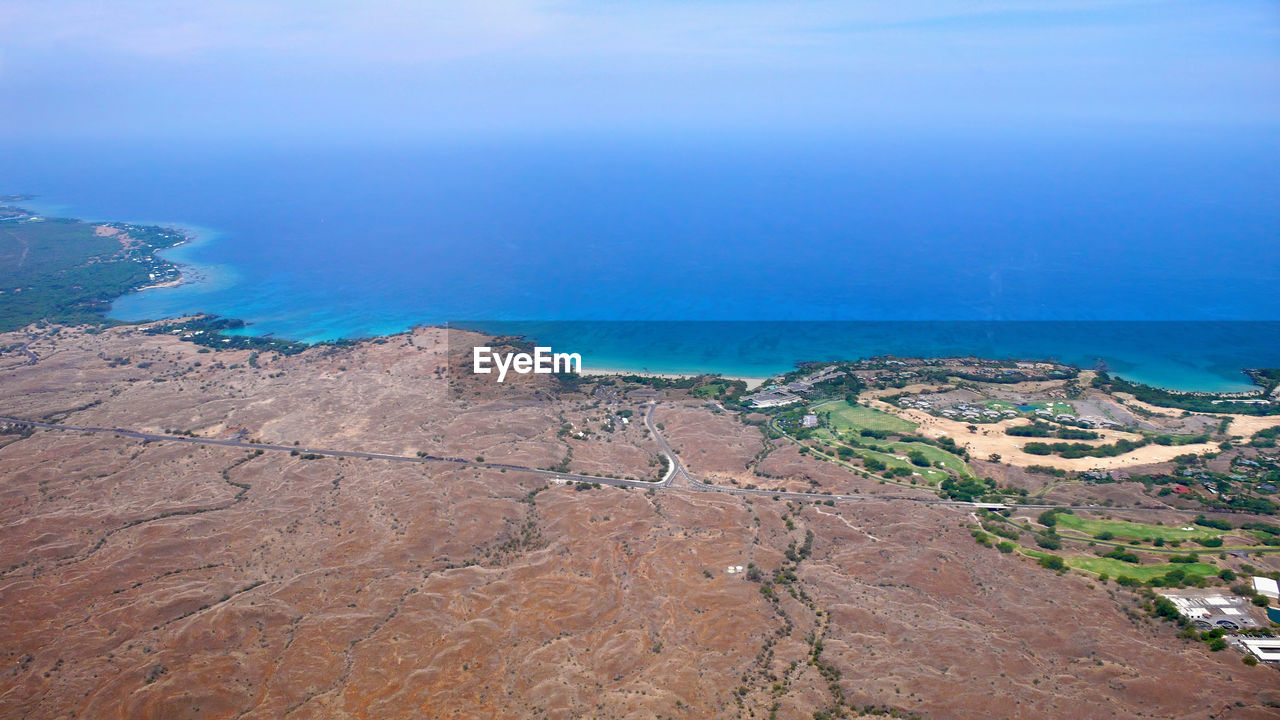 water, sea, land, scenics - nature, coast, nature, environment, beauty in nature, landscape, aerial photography, cliff, beach, travel destinations, tranquility, high angle view, terrain, sky, no people, tranquil scene, blue, travel, day, aerial view, outdoors, coastline, mountain, non-urban scene, bay, tourism, rock, island, idyllic, ocean, shore, horizon over water, architecture