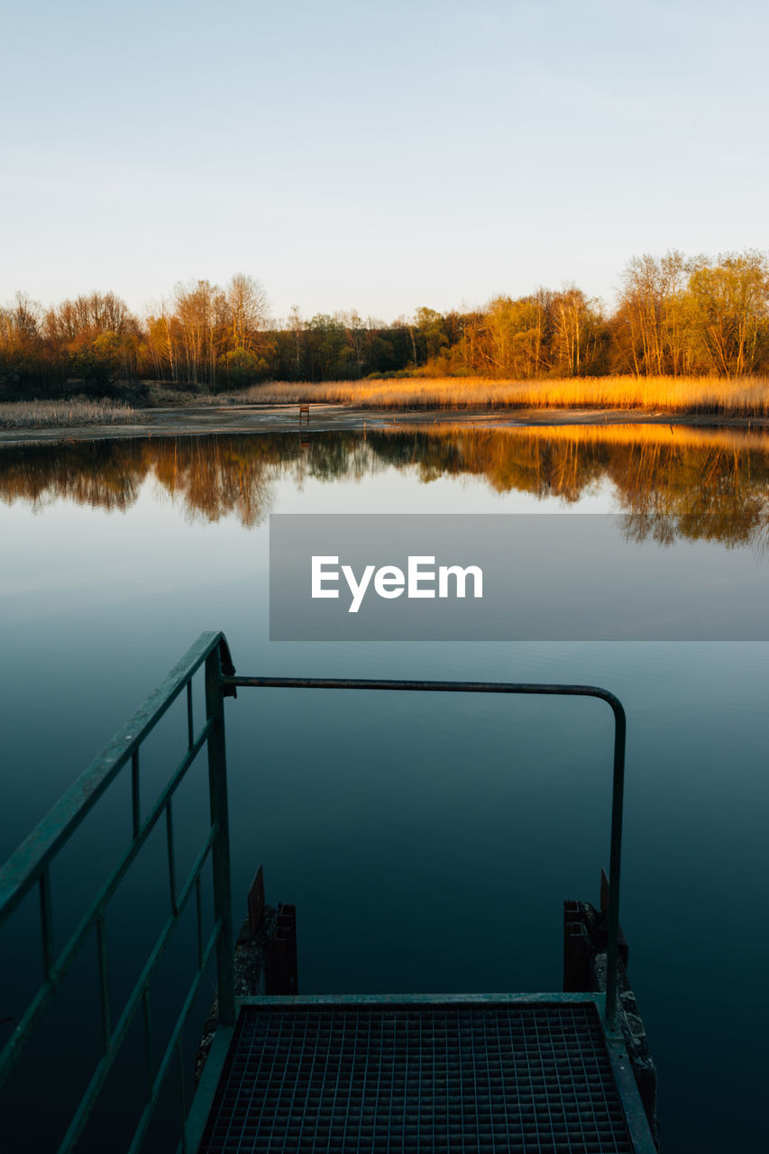 SCENIC VIEW OF CALM LAKE AGAINST CLEAR SKY