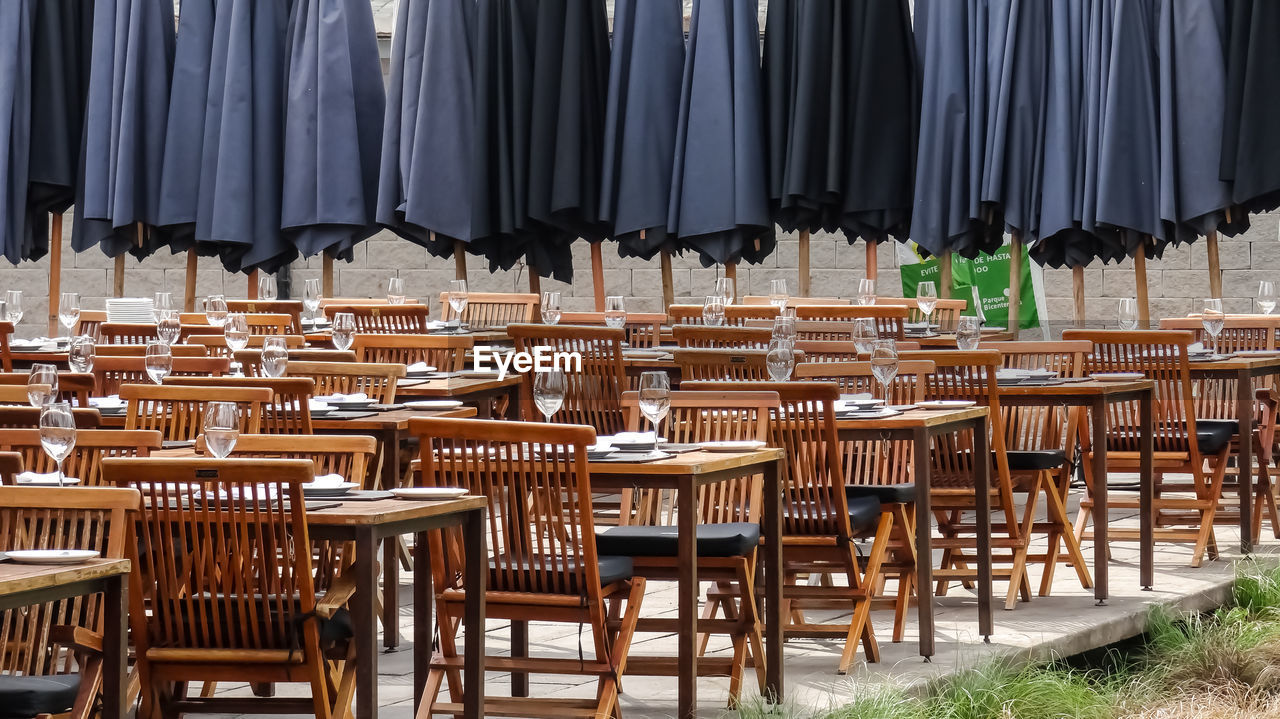 Empty chairs and tables in restaurant