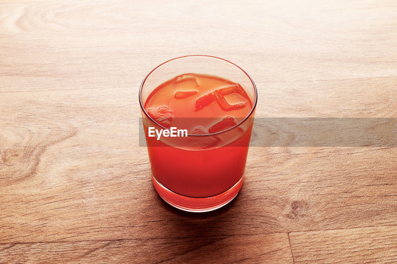 CLOSE-UP OF BEER GLASS ON TABLE