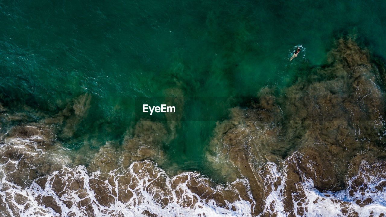 Aerial view of woman swimming in sea