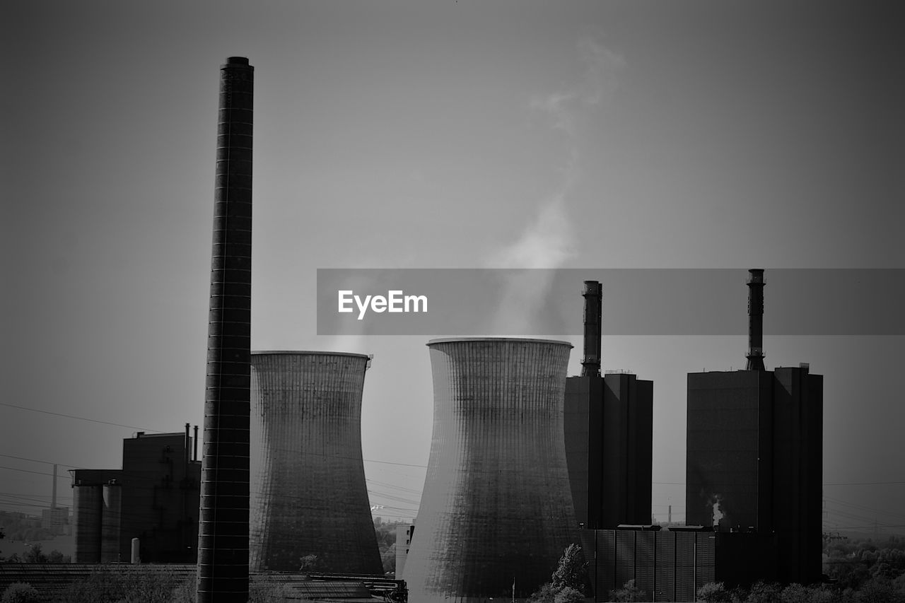 SMOKE STACKS AGAINST SKY