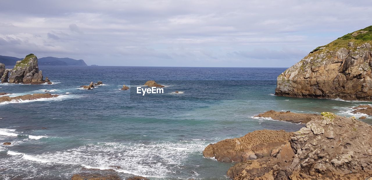SCENIC VIEW OF SEA AND ROCKS AGAINST SKY