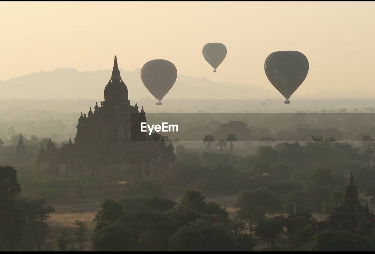 Hot air balloons against sky at sunset