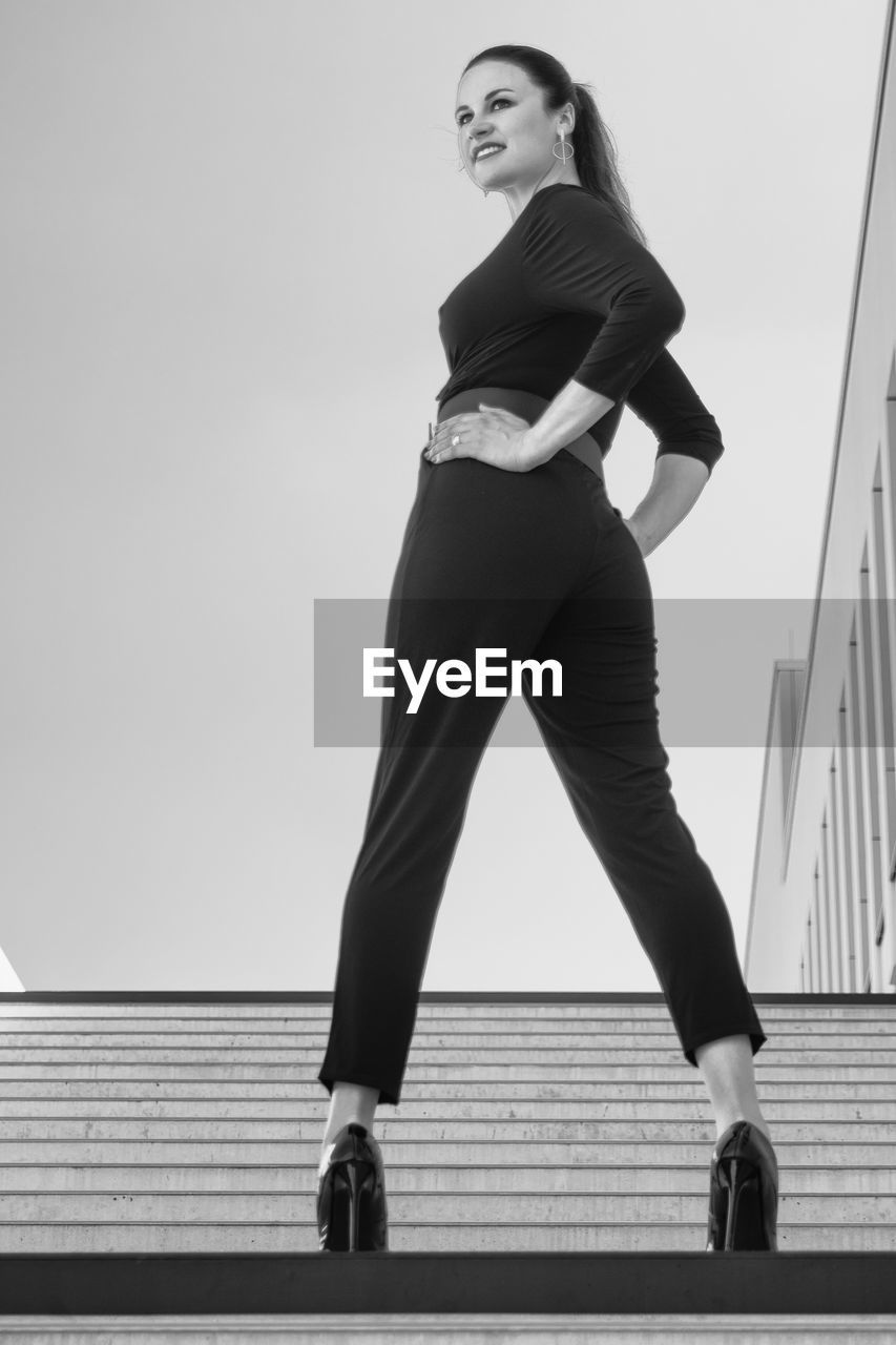 Full length portrait of woman against clear sky