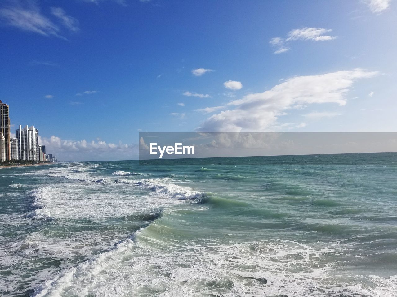 Scenic view of sea against cloudy sky