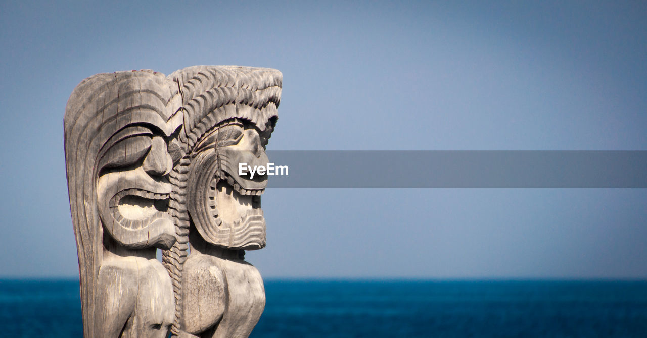 CLOSE-UP OF STATUE AGAINST SEA AND CLEAR SKY