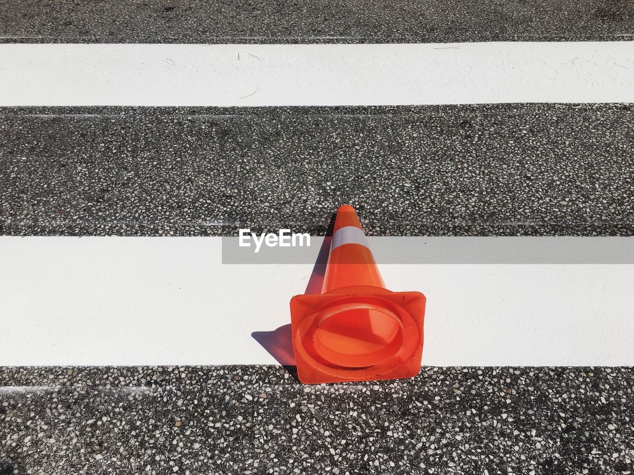 High angle view of traffic cone on zebra crossing