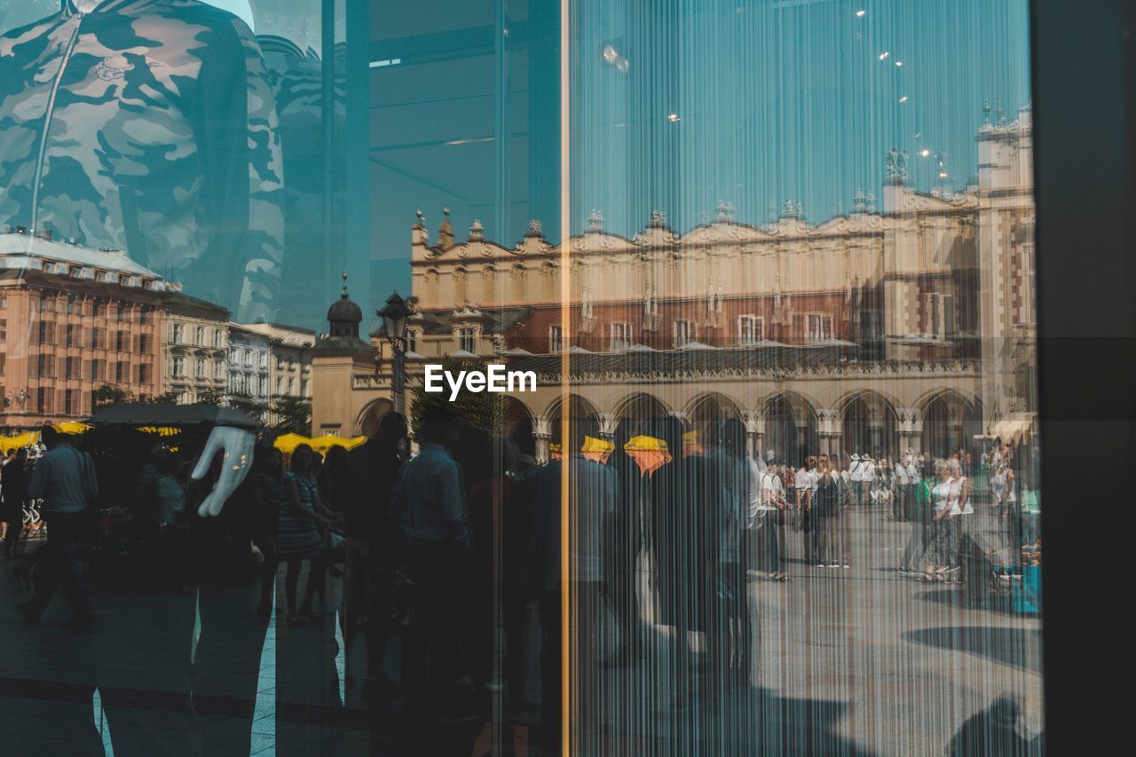 PEOPLE WALKING IN FRONT OF BUILDING