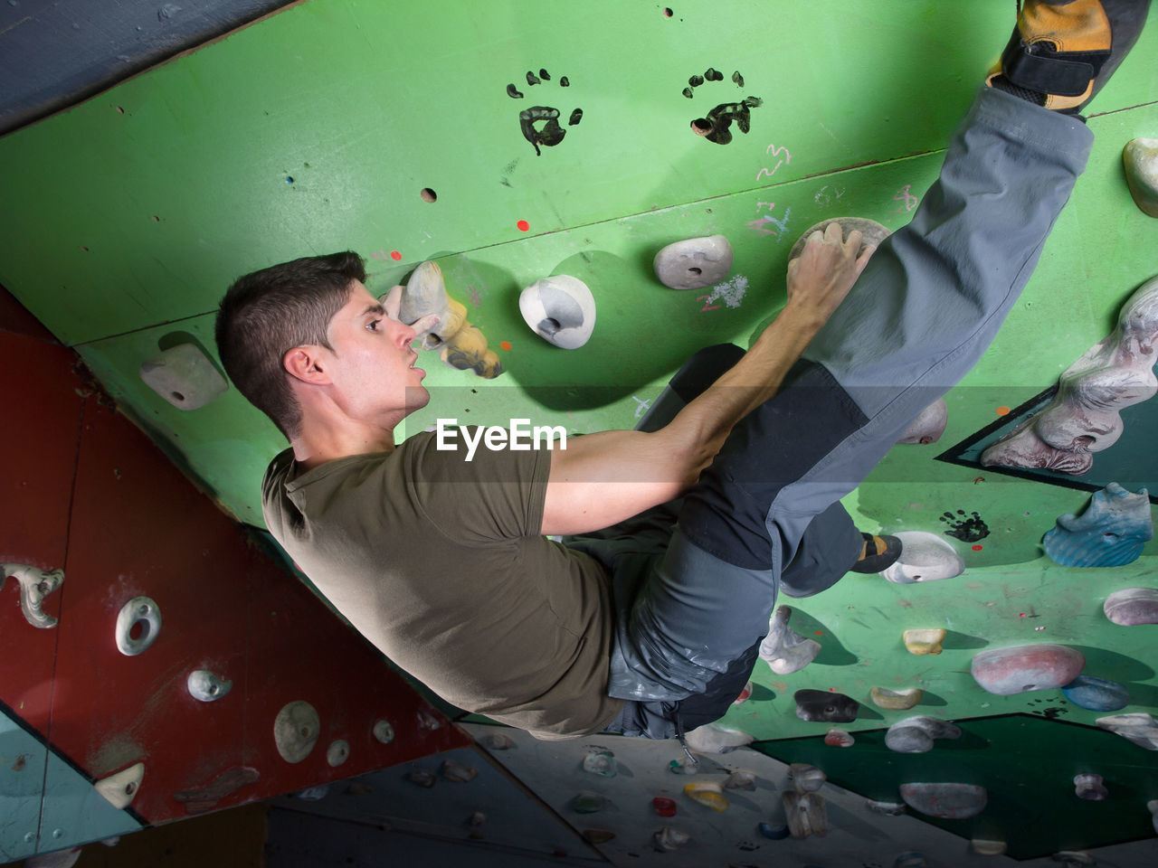 Full length of man climbing wall
