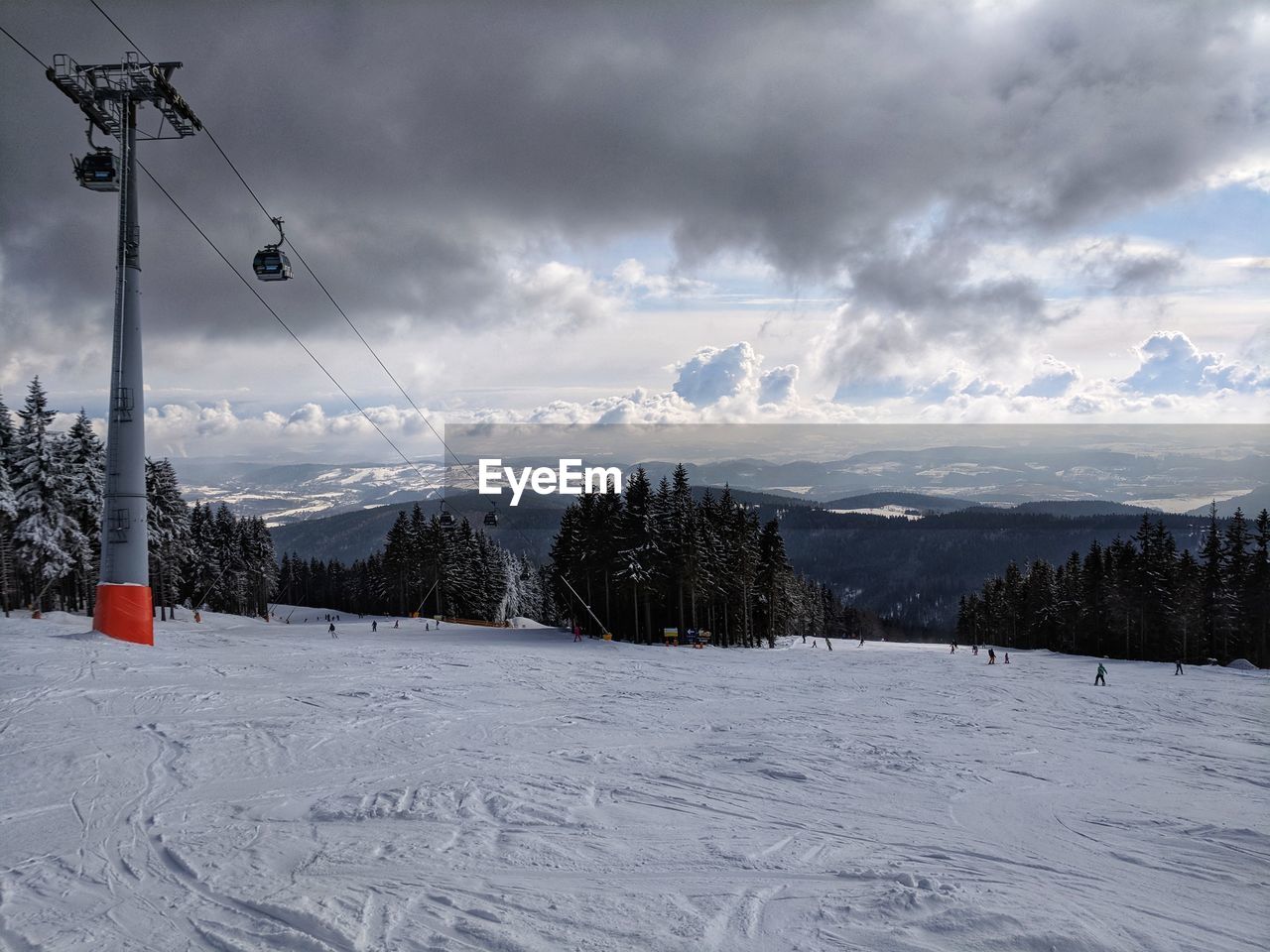 SKI LIFT OVER SNOW COVERED MOUNTAINS