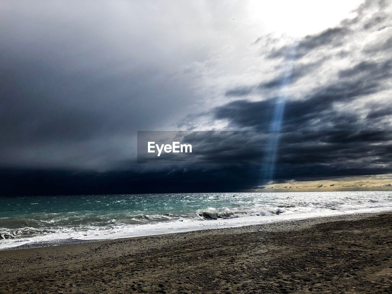 SCENIC VIEW OF SEA AGAINST STORM CLOUDS