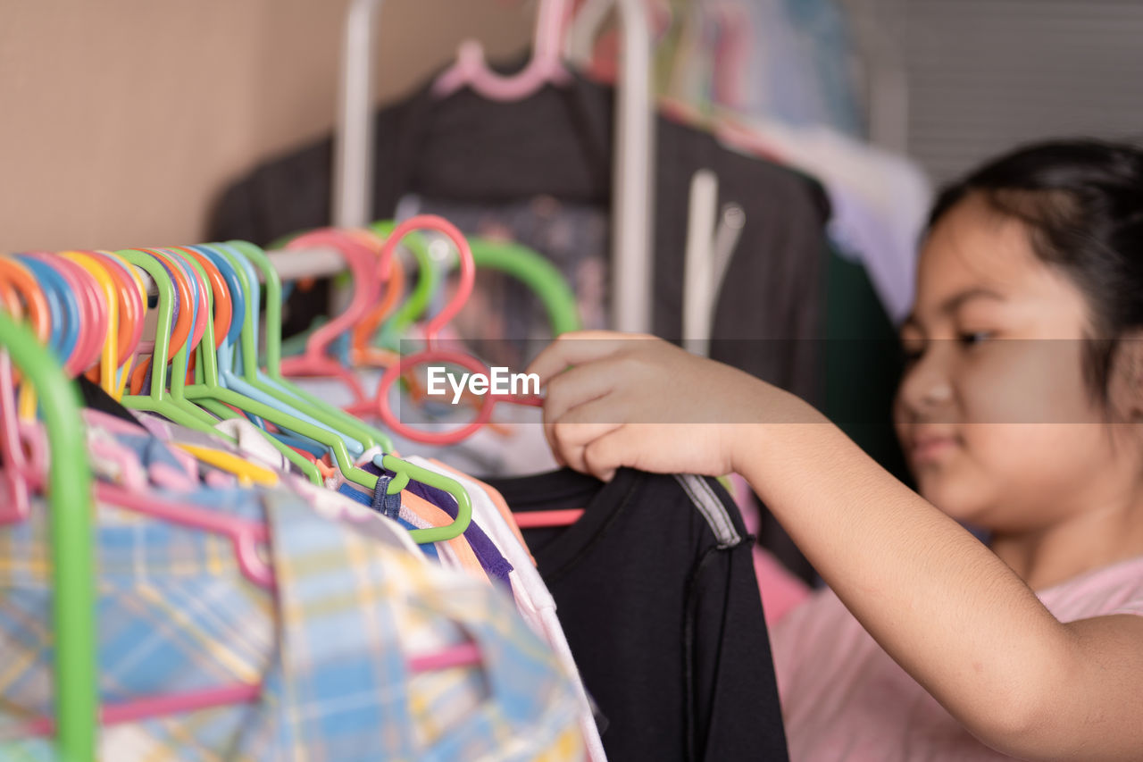 MIDSECTION OF BOY WEARING MULTI COLORED STORE AT DISPLAY