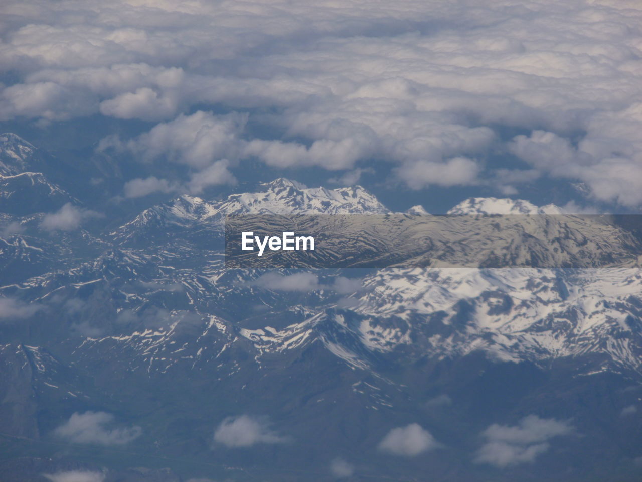 Scenic view of snow covered mountains against sky