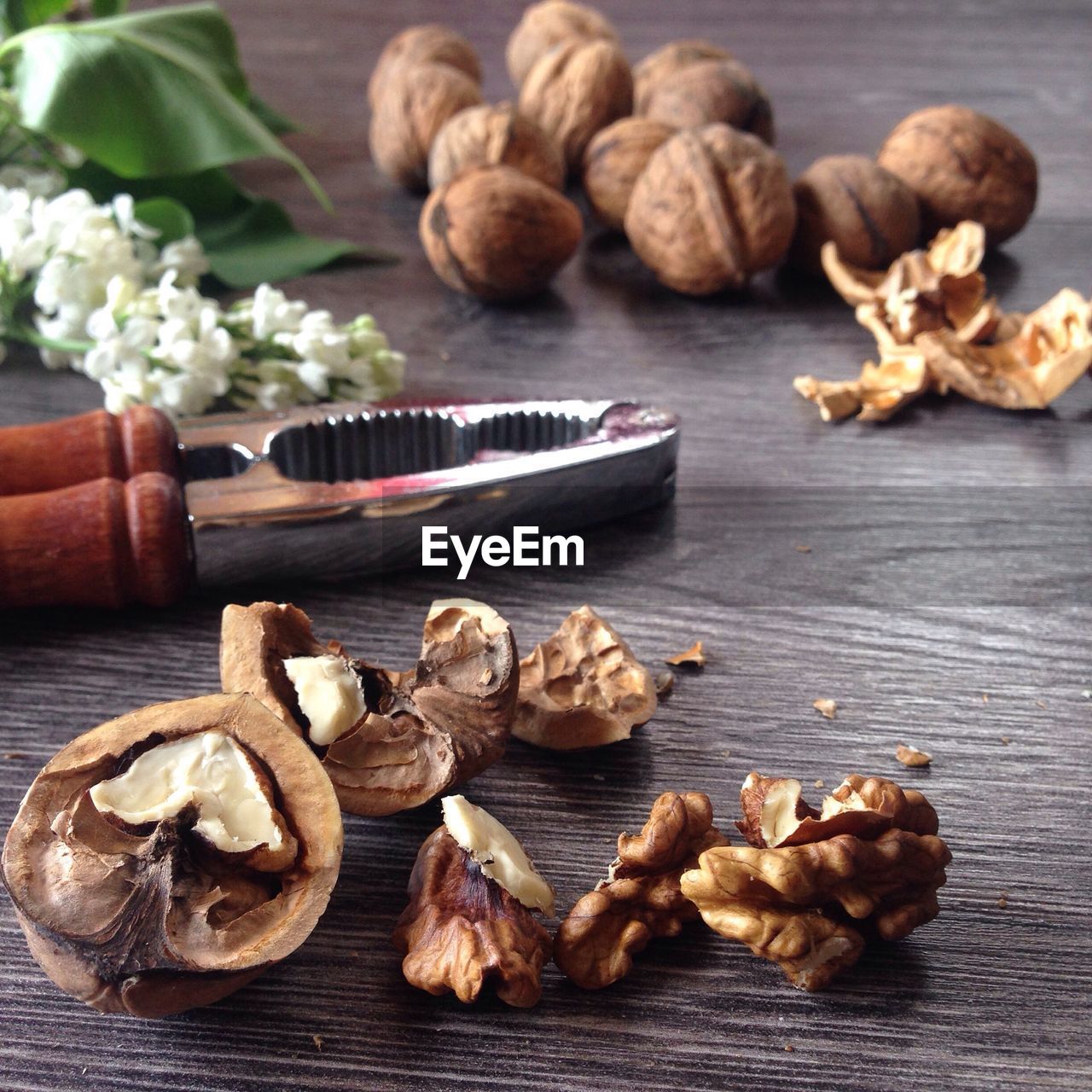 Close-up of walnut and nutcracker on table