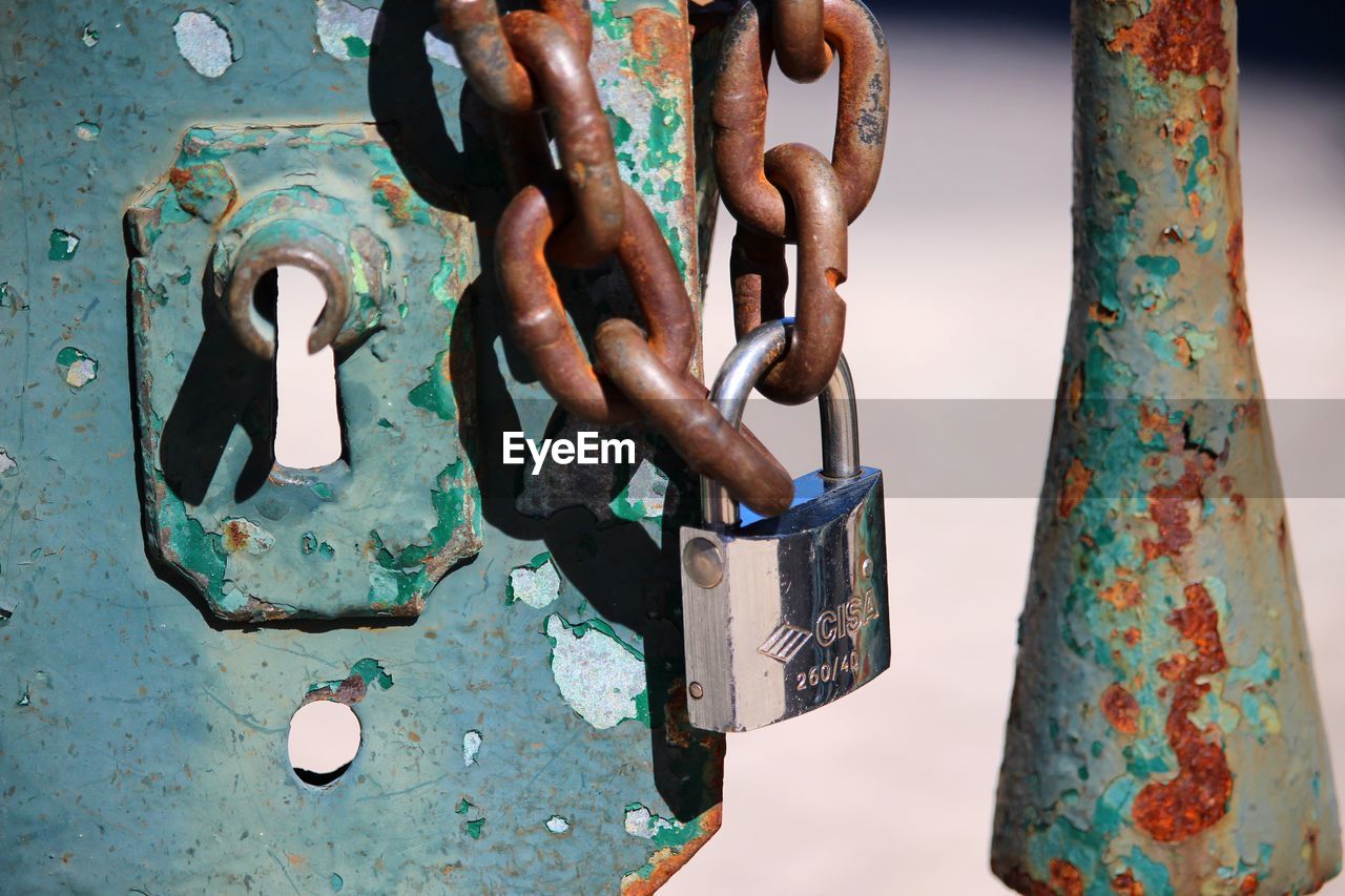 Close-up of padlocks on metal chain