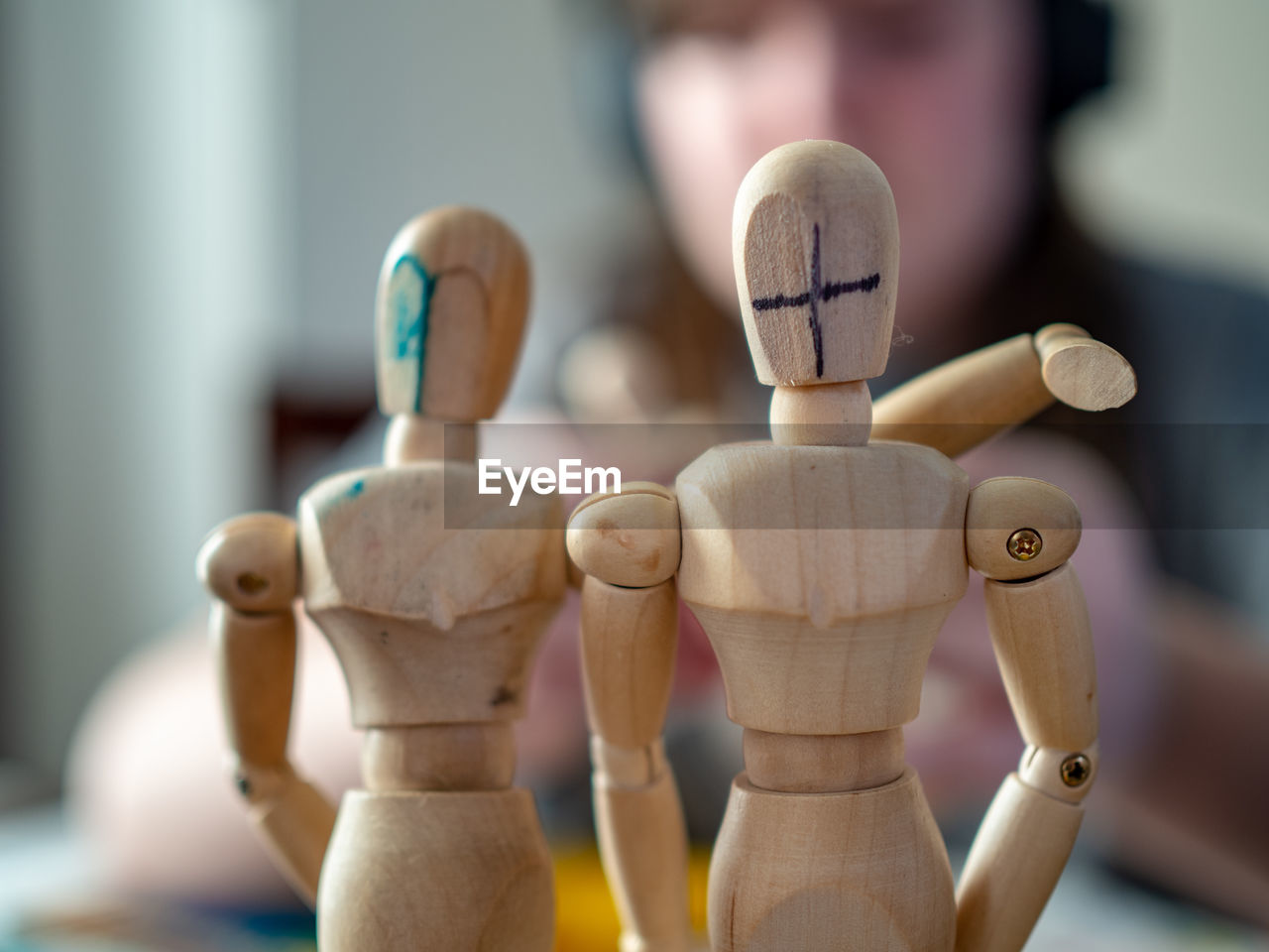 CLOSE-UP OF FIGURINE WITH TOY ON TABLE