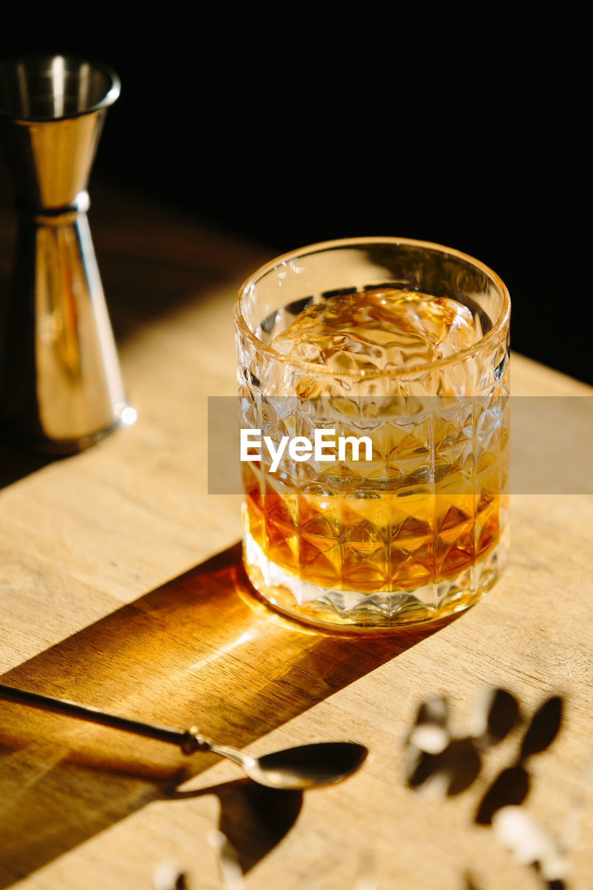 Close-up of glass with bourbon whiskey on table