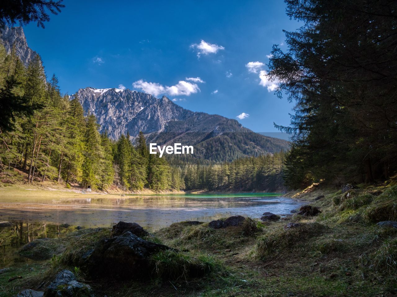 Scenic view of lake and mountains against sky