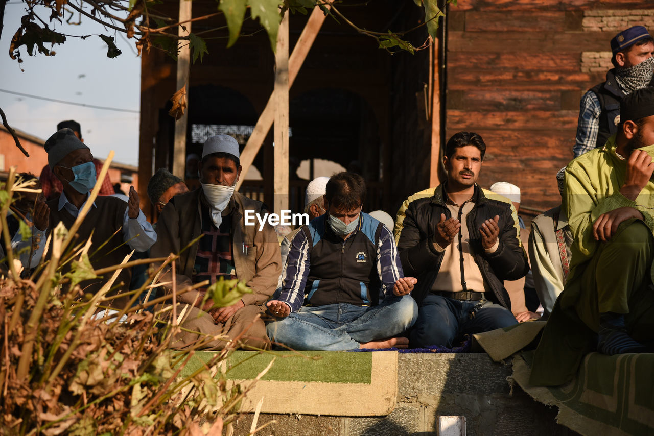 GROUP OF PEOPLE SITTING IN THE TEMPLE