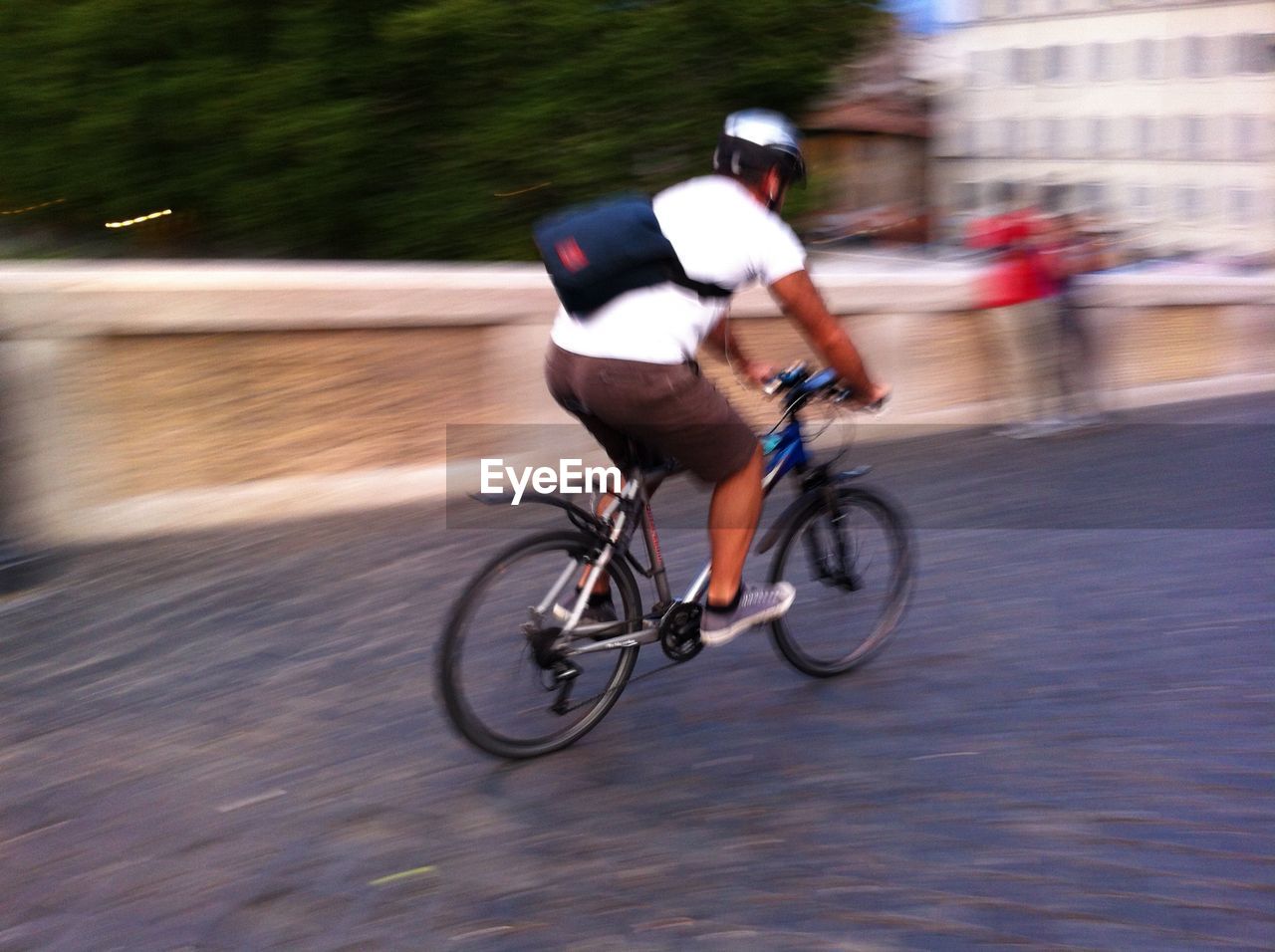 PEOPLE RIDING BICYCLE ON ROAD