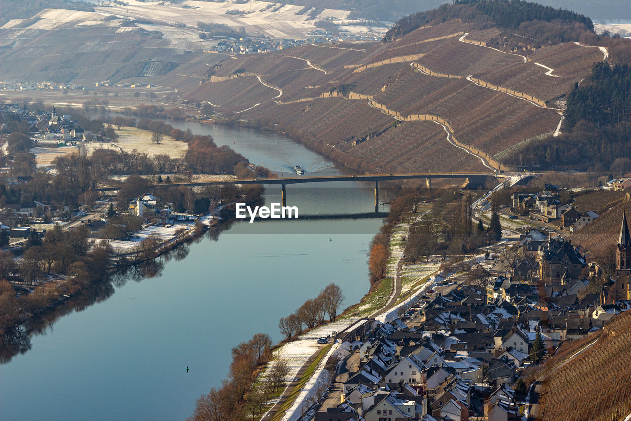 View on the valley of the river moselle and the wine villages mülheim and lieser in winter with snow