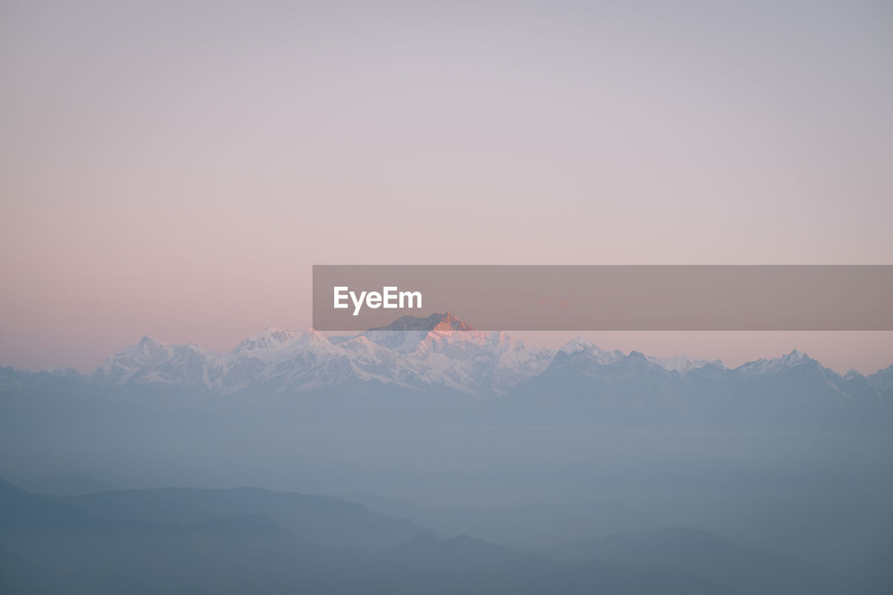 Scenic view of snowcapped mountains against sky during sunset