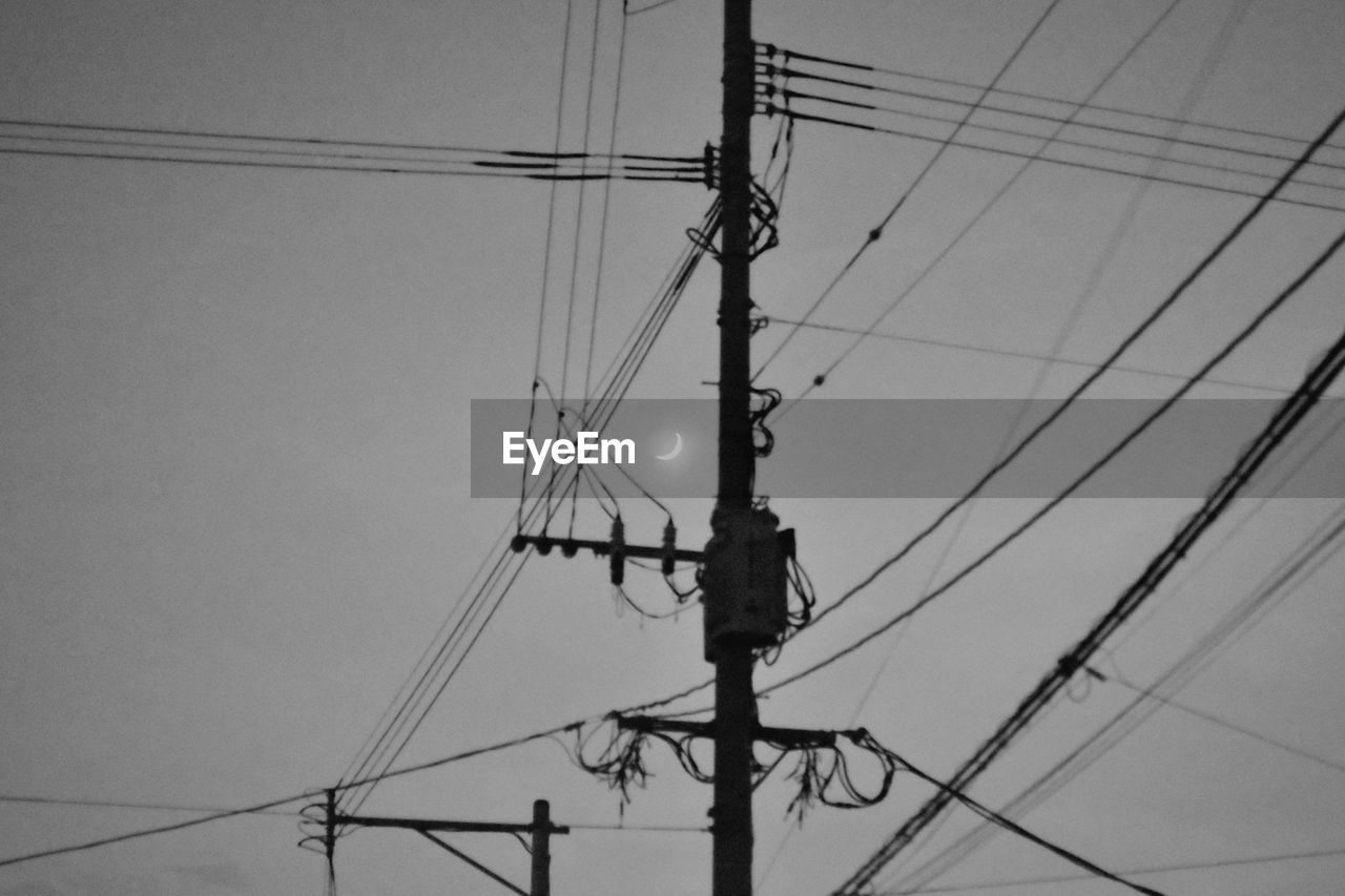 cable, electricity, technology, power supply, electricity pylon, power line, power generation, black and white, line, overhead power line, low angle view, monochrome, sky, complexity, monochrome photography, no people, transmission tower, electrical supply, telephone pole, telephone line, nature, communication, public utility, day, lighting, outdoors, telephone, silhouette