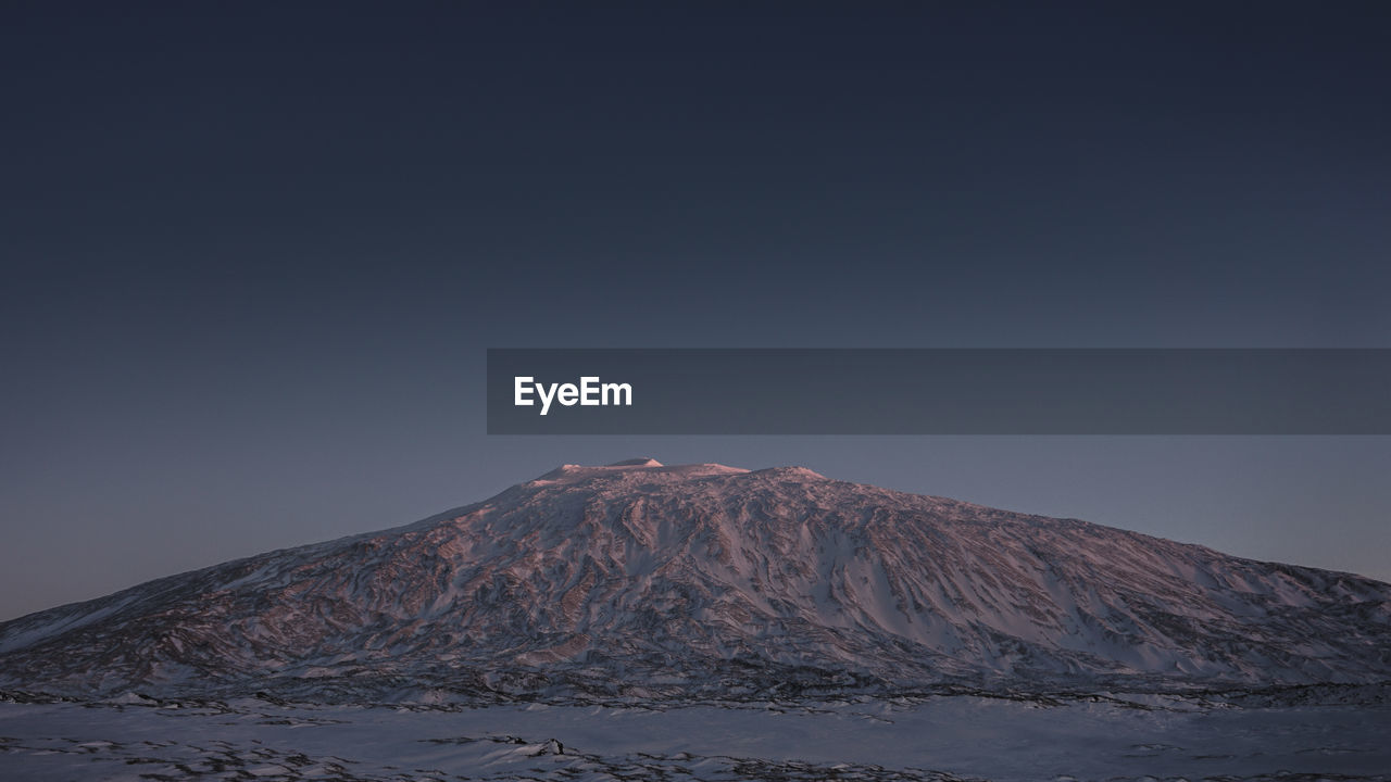 VIEW OF SNOWCAPPED MOUNTAIN AGAINST SKY