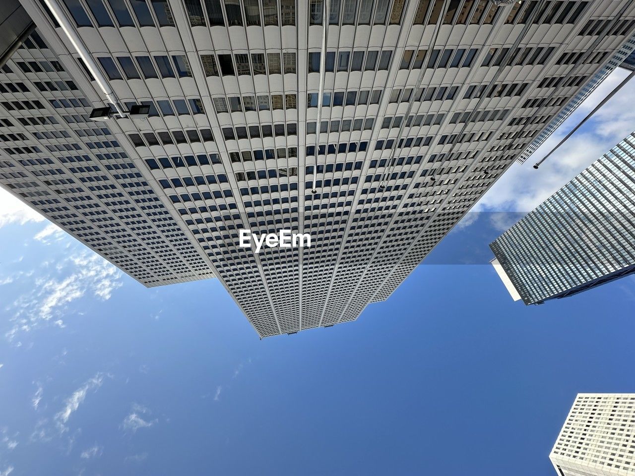 low angle view of skyscraper against blue sky