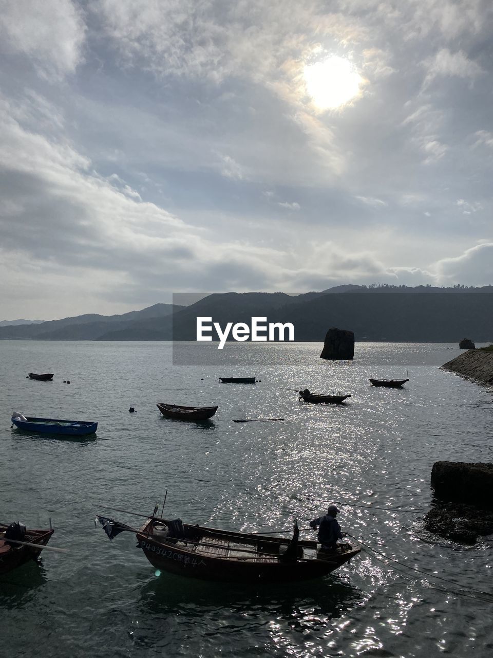 FISHING BOATS IN SEA AGAINST SKY