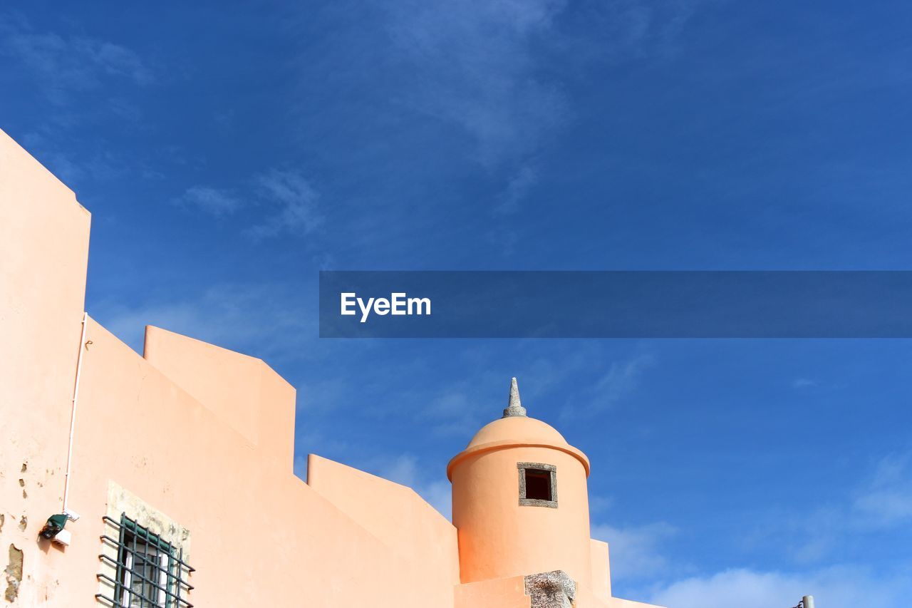 Low angle view of buildings against blue sky