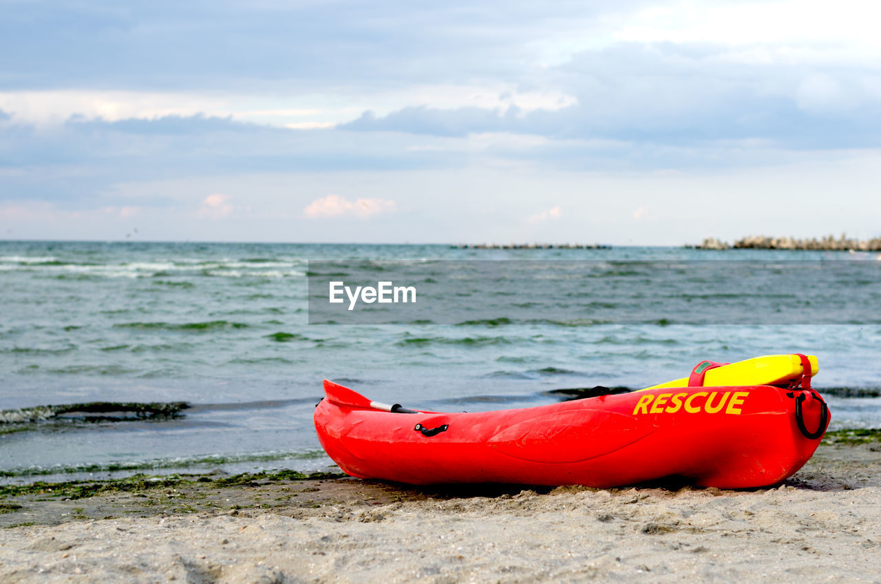 VIEW OF RED BOAT ON BEACH