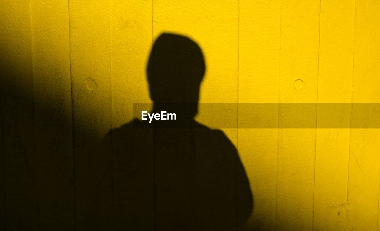 SHADOW OF PERSON ON WALL