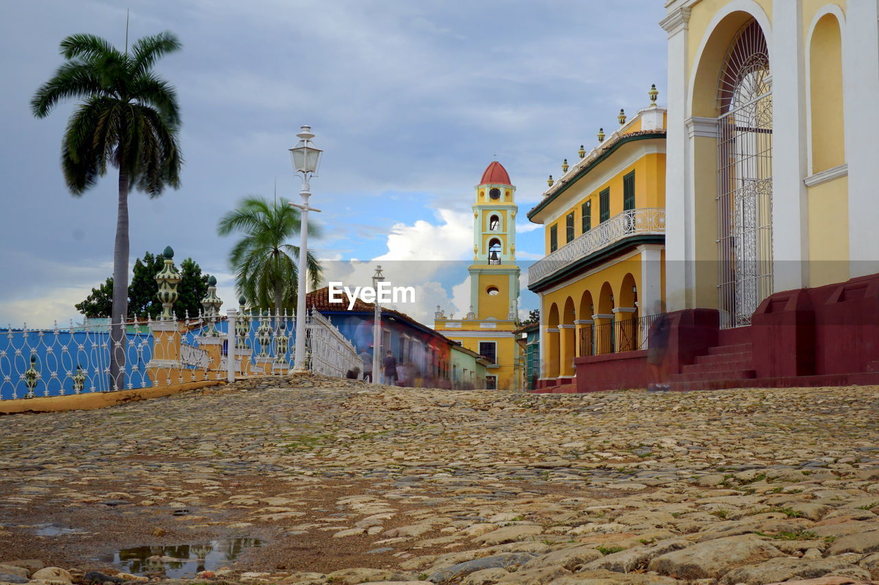 Palm trees and church against sky