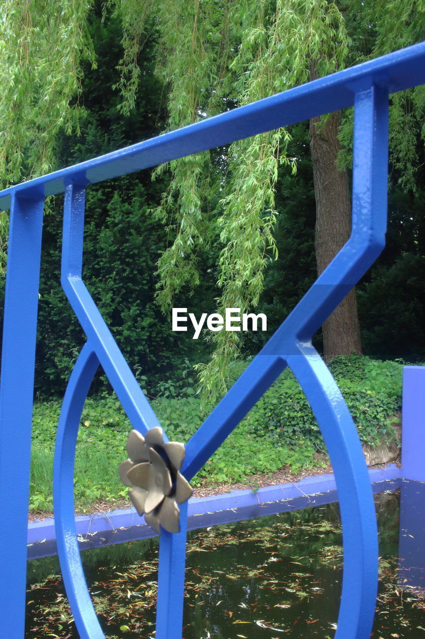 CLOSE-UP OF PLAYGROUND EQUIPMENT AGAINST TREES