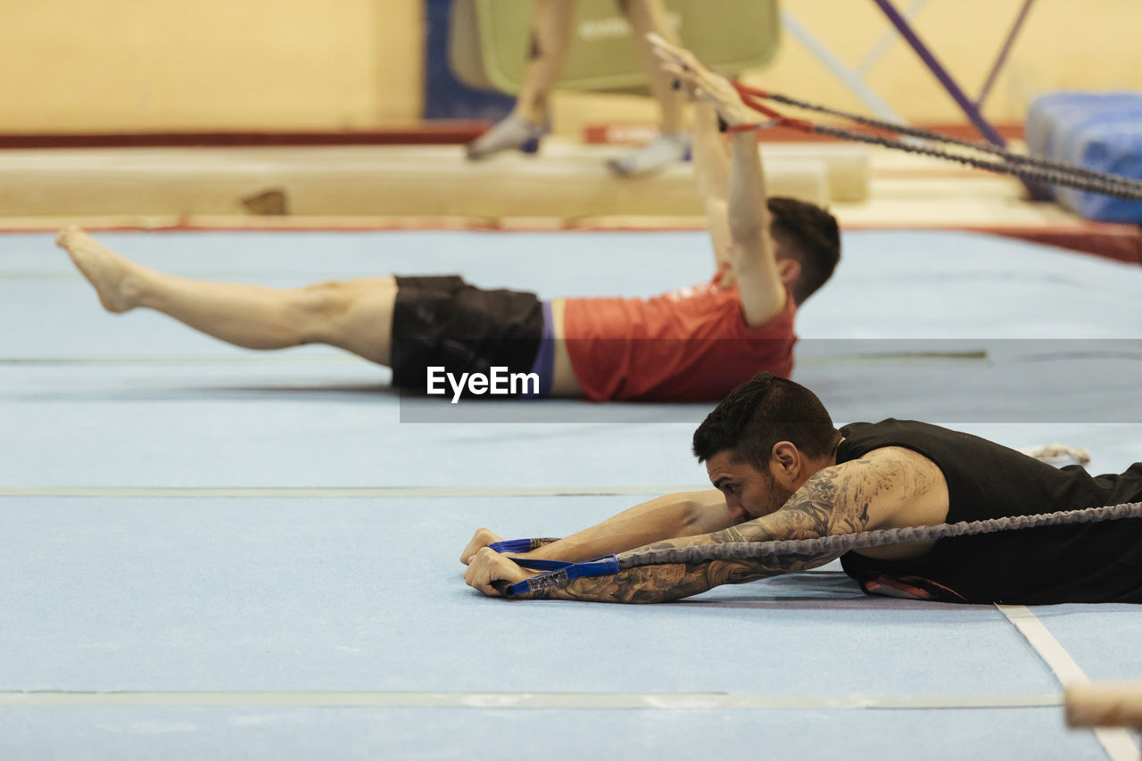 Mid adult men exercising in gym