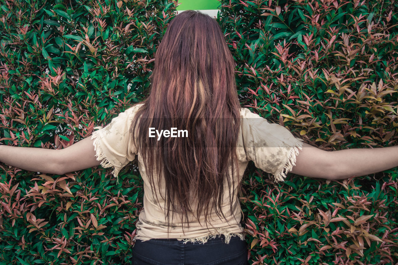 Woman standing in front of plants