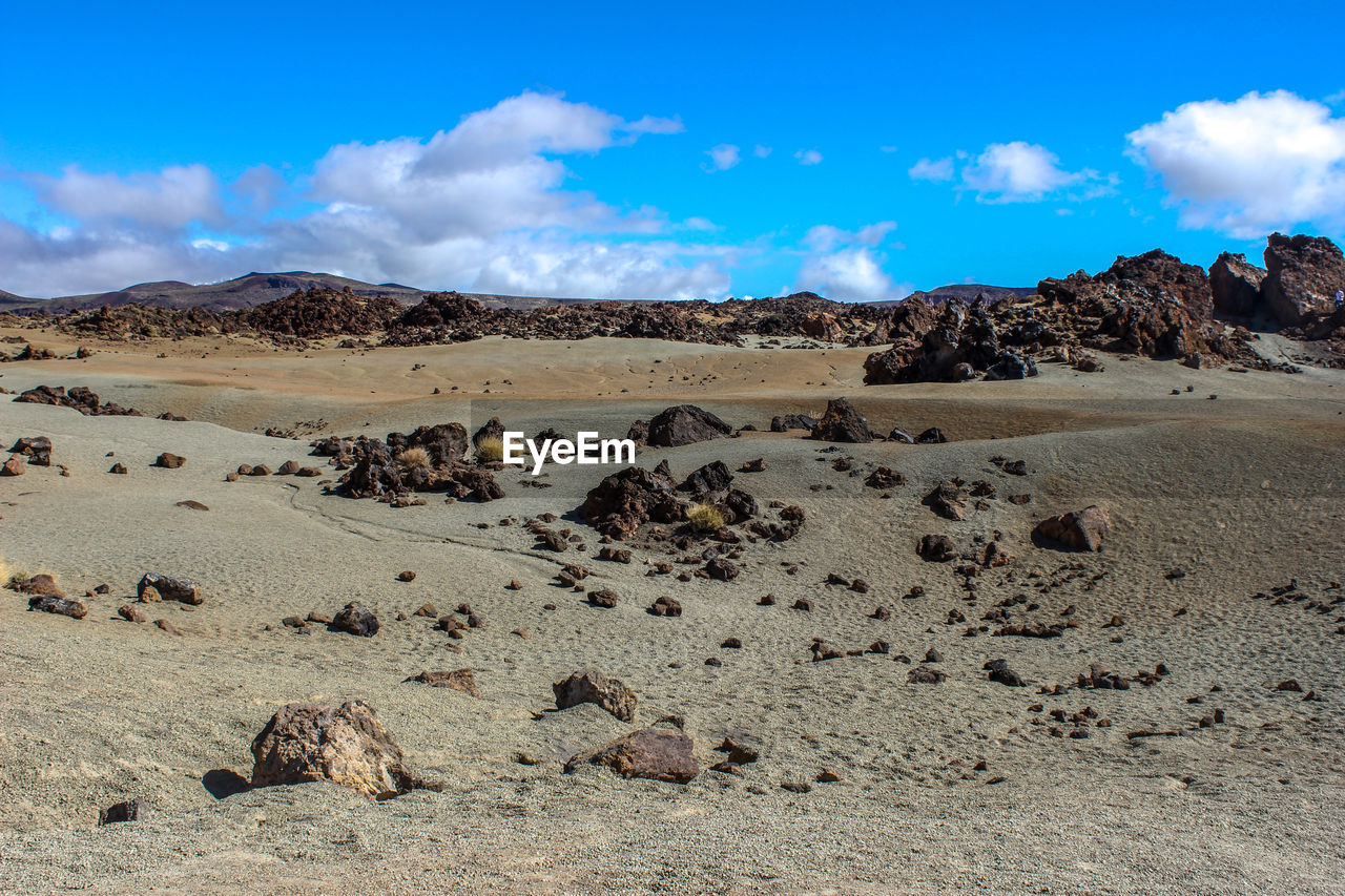 Scenic view of arid landscape against sky