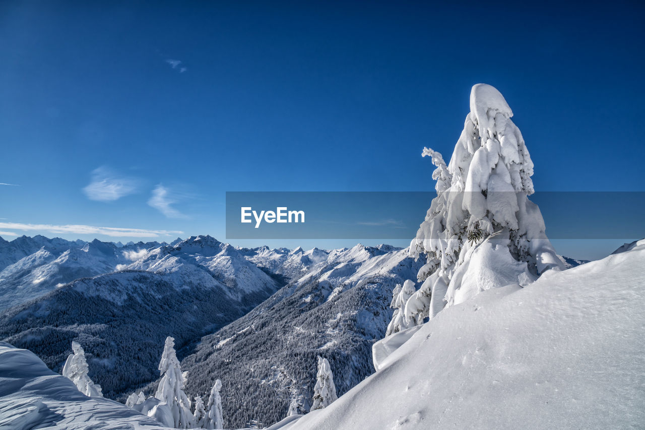 scenic view of snowcapped mountains against clear blue sky