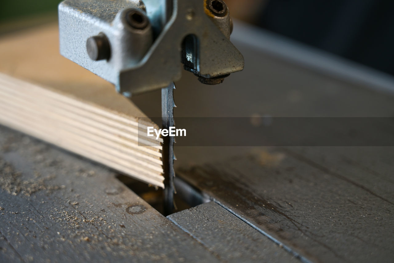 CLOSE-UP OF MACHINE PART ON METAL STRUCTURE