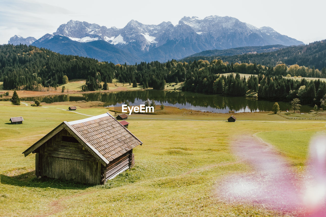 Scenic view of field and mountains against sky