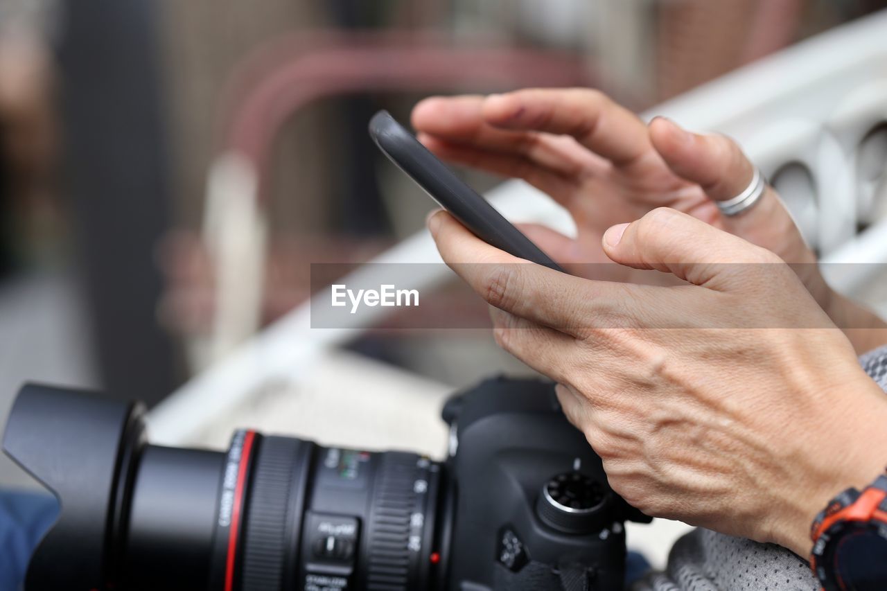 CLOSE-UP OF MAN PHOTOGRAPHING WITH MOBILE PHONE